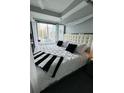 Cozy bedroom featuring a tufted headboard and modern style at 285 Centennial Olympic Park Nw Dr # 1905, Atlanta, GA 30339