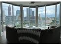 Stylish living room with floor-to-ceiling windows and stunning city views at 285 Centennial Olympic Park Nw Dr # 1905, Atlanta, GA 30339