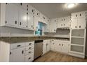 Bright kitchen featuring white cabinets, granite countertops, and stainless steel appliances at 420 Creekview Ct, Marietta, GA 30064