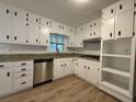 Bright kitchen featuring white cabinets, granite countertops, and stainless steel appliances at 420 Creekview Ct, Marietta, GA 30064