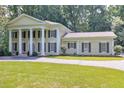 Lovely exterior view of home with symmetrical facade and well-manicured lawn at 575 Valley Hall Dr, Sandy Springs, GA 30350