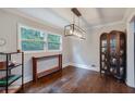 Dining area featuring hardwood floors, modern light fixture, and large window with backyard view at 2142 Troutdale Dr, Decatur, GA 30032