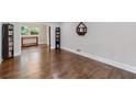 Hardwood floors gleam in this living room space with view of the adjacent room at 2142 Troutdale Dr, Decatur, GA 30032