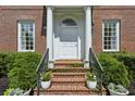 Inviting front entrance with brick steps, white columns, and manicured greenery at 2671 Bohler Nw Rd, Atlanta, GA 30327