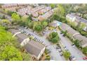 Aerial view of the complex with swimming pool, mature trees, car park and multiple apartment buildings at 3160 Seven Pines Unit 105 Ct, Atlanta, GA 30339