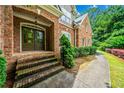 Charming brick home featuring a lovely front entrance with a walkway and manicured landscaping at 205 Camden Creek Ct, Lawrenceville, GA 30043