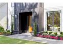 Close up of the elegant front entrance with black trim, well-maintained landscaping, and a inviting walkway at 2297 Nesbitt Ne Dr, Brookhaven, GA 30319