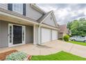 Attractive home exterior with well-maintained lawn, brick accents, and two-car garage at 4271 Brighton Nw Way, Kennesaw, GA 30144