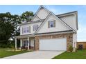 Two-story home featuring stone veneer, well-maintained lawn, and a two-car garage at 437 Autrey Dr, Douglasville, GA 30134