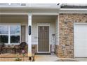 Inviting front porch with stone accents, a cozy seating area, and a welcoming entrance at 437 Autrey Dr, Douglasville, GA 30134