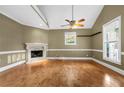 Spacious living room with hardwood floors, fireplace, and large windows offering ample natural light at 4594 Poplar Rd, Pine Lake, GA 30072