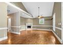 Spacious living room with hardwood floors, fireplace, and large windows offering ample natural light at 4594 Poplar Rd, Pine Lake, GA 30072