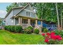 Beautifully landscaped front yard with vibrant roses and a charming view of the home's exterior at 177 Ridgeland Ave, Decatur, GA 30030