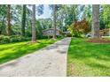 Exterior shot showcases a home with a long driveway surrounded by a lush green lawn at 3027 Vista Brook Dr, Decatur, GA 30033