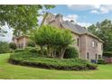 Landscaped backyard featuring lush greenery and mature trees, offering a private and serene outdoor space at 3099 Hidden Falls Dr, Buford, GA 30519