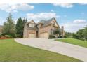 Spacious driveway leading to a three-car garage on this beautiful brick home with well-manicured lawn at 3099 Hidden Falls Dr, Buford, GA 30519