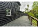 Side and back view of deck with wood and metal railing and a lush green yard beyond at 5254 Greenpoint Drive, Stone Mountain, GA 30088