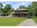 Charming two-story home with a welcoming front porch and lush green lawn at 5254 Greenpoint Drive, Stone Mountain, GA 30088