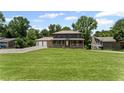 Charming two-story home with a welcoming front porch and lush green lawn at 5254 Greenpoint Drive, Stone Mountain, GA 30088