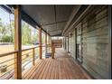 Long front porch made of wood with gray railings, a gray ceiling, and wood posts at 5254 Greenpoint Drive, Stone Mountain, GA 30088