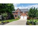 Beautiful two-story brick home with a well-manicured lawn and landscaping at 1775 Porterton Way, Cumming, GA 30041