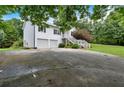 Side angle of home featuring a spacious driveway and neat, attractive landscaping at 33 Moriah Ne Way, Rydal, GA 30171