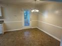 Cozy dining area featuring a classic light fixture and access to the backyard at 5000 Saxony Ct, Stone Mountain, GA 30083