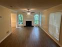 Spacious living room with lots of natural light, wood floors, and a cozy fireplace at 5000 Saxony Ct, Stone Mountain, GA 30083