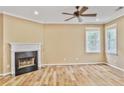 Inviting living room features a cozy fireplace, ceiling fan and bright windows, perfect for relaxing and entertaining at 747 Gardenside Se Cir, Marietta, GA 30067