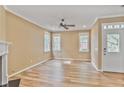 Bright living room boasts wood flooring, a fireplace, ceiling fan, and natural light from multiple windows at 747 Gardenside Se Cir, Marietta, GA 30067