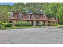 Inviting condo complex with mature trees, manicured landscaping, and ample parking at 2972 Parc Lorraine, Lithonia, GA 30038