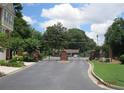 Gated community entrance with brick pillars and lush landscaping, offering security and curb appeal at 2975 Wintercrest Trce, Dunwoody, GA 30360