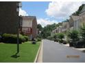 A well maintained street view featuring sidewalks, grass lawns, and meticulously arranged shrubbery at 2975 Wintercrest Trce, Dunwoody, GA 30360