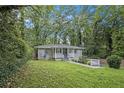 Inviting one-story house with a well-maintained lawn and landscaped garden, nestled among lush trees at 86 Stratford Nw Dr, Atlanta, GA 30311