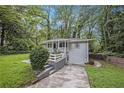 Attractive one-story home features a lush front yard, showcasing its curb appeal and tranquil setting at 86 Stratford Nw Dr, Atlanta, GA 30311