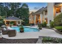 Inviting backyard pool with cabana, lounging area and manicured landscaping at 1500 Historic Vw, Stone Mountain, GA 30087