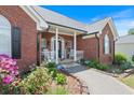 Inviting brick home with a cozy front porch, beautiful landscaping, and a welcoming entrance at 20 Friendship Rd, Euharlee, GA 30145