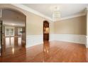 Elegant living room with gleaming hardwood floors, white trim, and an archway leading to other spaces at 2774 Birch Grove Se Ln # 11, Marietta, GA 30067
