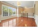 Spacious living room with hardwood floors, a large window, and classic trim accents throughout at 2774 Birch Grove Se Ln # 11, Marietta, GA 30067
