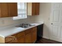 Functional kitchen featuring wood cabinets, a double sink, and essential appliances at 504 Edgewood Trce, Mcdonough, GA 30253