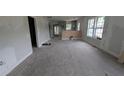 Large living room with bare concrete floors and kitchen in the background at 854 Mcdonough Se Blvd, Atlanta, GA 30315
