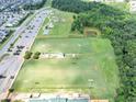 Aerial view of well-maintained sports fields, playground, and wooded area near a residential area at 109 Paulownia Cir, Mcdonough, GA 30253
