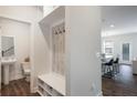 Convenient mudroom featuring built-in bench, hooks, and storage cubbies adjacent to a half bathroom and kitchen at 319 Hayden Cir, Woodstock, GA 30189