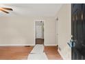 Open concept living room with hardwood flooring, neutral paint, and lots of natural light at 4039 Tanglewood Rd, Snellville, GA 30039