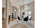 Bright dining area with large windows, modern chandelier, and elegant columns at 1635 Lake Heights Cir, Dacula, GA 30019