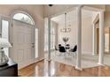 Welcoming foyer with hardwood floors, tall columns, and a contemporary chandelier above the dining area at 1635 Lake Heights Cir, Dacula, GA 30019