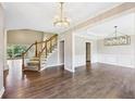 Elegant foyer featuring hardwood floors, staircase, and modern chandelier at 4685 Braselton Hwy, Hoschton, GA 30548