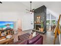 Comfortable living room with stone fireplace, vaulted ceiling, and seamless access to dining area at 5077 Martindale Ln, Stone Mountain, GA 30088