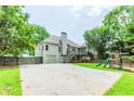 Backyard with a deck, stairs, a two-car garage, and playground area at 1122 Cayuga Ct, Dacula, GA 30019