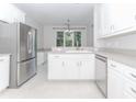 Bright and clean kitchen featuring all-white cabinets and stainless steel appliances at 1122 Cayuga Ct, Dacula, GA 30019